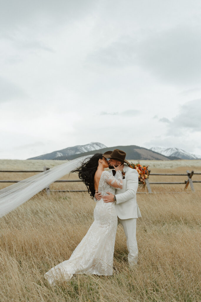 Bride and groom share a kiss during their Sage Lodge wedding in Paradise Valley Montana